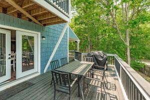 a deck with a table and chairs on a blue house at Blue Skies by Railey Vacations in Oakland