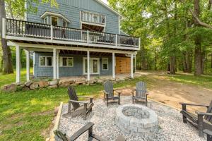 a house with chairs and a fire pit in the yard at Blue Skies by Railey Vacations in Oakland