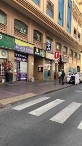an empty street in front of a building at ALFUTTAIN Vacation Homes Rental in Dubai