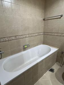 a white bath tub in a bathroom at ALFUTTAIN Vacation Homes Rental in Dubai +69 photos