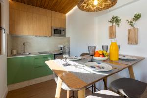 a kitchen with a table with a bowl of fruit on it at Pickman Suites in Seville