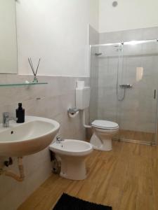 a bathroom with a sink and a toilet and a shower at Seven B&b in Casalmorano +40 photos