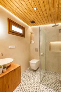 a bathroom with a toilet and a sink and a shower at Pickman Suites in Seville +58 photos