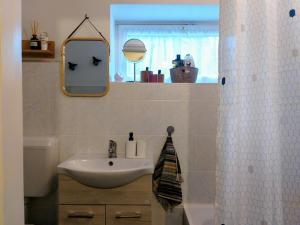 a bathroom with a sink and a mirror at Arany Virág Vendégház in Mór +66 photos