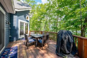 a patio with a table and chairs on a deck at Blue Stone Lodge by Railey Vacations in Swanton +28 photos