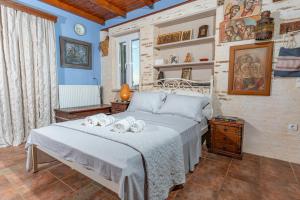 a bedroom with a bed with towels on it at Villa Art Natalie two in Kithnos +78 photos