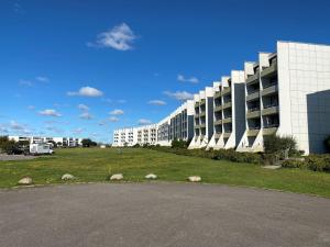 a large building with a grass field in front of it at Kaept-ns-Inn in Burgtiefe auf Fehmarn 