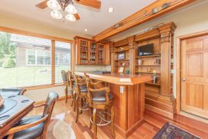 a kitchen with a large wooden bar with chairs at Boulder Creek Lodge by Railey Vacations in McHenry