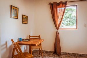 a room with a wooden table and a window at Casa Rosaz in Cavalcante
