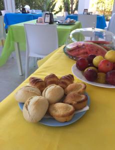 two plates of pastries and fruit on a table at ItineraBaiaVerde Rooms & Breakfast in Gallipoli