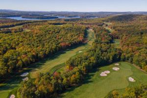 an aerial view of a golf course with trees at Bourbon Sunset by Railey Vacations in Swanton