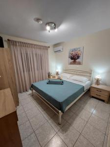 a bedroom with a bed and a table in it at Alexandra by the Sea in Nea Peramos