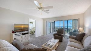 a living room with a flat screen tv and a couch at Crescent Royale Condominiums 515 in Siesta Key
