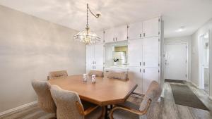 a dining room with a wooden table and chairs at Crescent Royale Condominiums 515 in Siesta Key