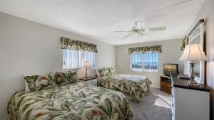a bedroom with a bed and a desk and a tv at Crescent Royale Condominiums 515 in Siesta Key +42 photos