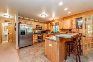 a kitchen with wooden cabinets and a stainless steel refrigerator at Bucks Run by Railey Vacations in Oakland