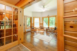 a living room with wooden floors and a ceiling fan at Bucks Run by Railey Vacations in Oakland