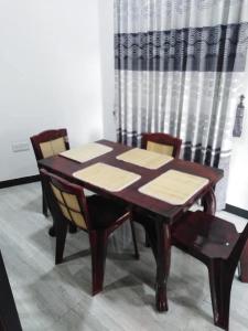 a dining room table with chairs and a wooden table at Lake parth Giritale in Giritale