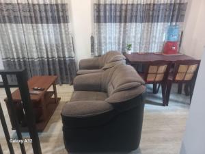 a living room with a chair with a blanket on it at Lake parth Giritale in Giritale +2 photos