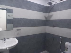 a bathroom with a sink and a mirror and a shower at Lake parth Giritale in Giritale