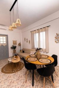 a living room with two tables and a couch at DM Seaside House in Perissa +23 photos