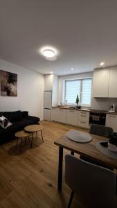 a living room with a couch and a table at MICKIEWICZ HOUSE Apartamenty in Wadowice