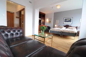 a living room with a couch and a bed and a table at Quality Hotel Bodensia in Boden