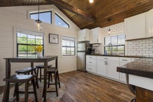 a kitchen with white cabinets and a table and chairs at Modern Pond-View Cabin Near Lake of Egypt in Marion