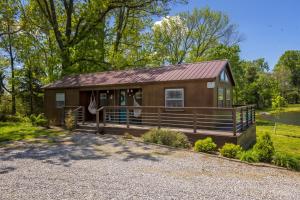 a small cabin with a porch and a deck at Modern Pond-View Cabin Near Lake of Egypt in Marion +31 photos