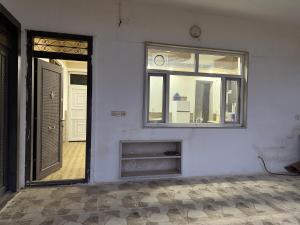 an empty room with a window and a door at Happy farm in Erbil