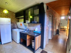 a kitchen with a sink and a refrigerator at ESPACIO MINGA, casa quinta en la ciudad, hasta 8 personas in Corrientes