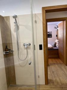 a shower with a glass door in a bathroom at Haus Steinplatte in Waidring +66 photos