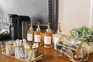 a group of bottles of alcohol sitting on a table at Spacious studio condo in historic Munger Place in Dallas