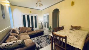 a living room with a couch and a table at Stay Ra3 Suites in Cairo