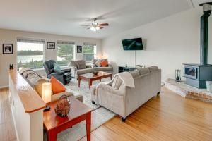 a living room with couches and a fireplace at Private Beach, Deck & Grill! Siuslaw River Getaway in Florence