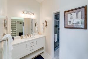 a white bathroom with a sink and a mirror at Private Beach, Deck & Grill! Siuslaw River Getaway in Florence +25 photos
