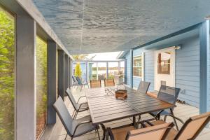 a deck with a wooden table and chairs on a house at Private Beach, Deck & Grill! Siuslaw River Getaway in Florence