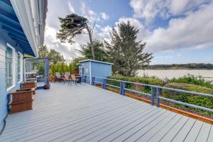a large deck with a view of the water at Private Beach, Deck & Grill! Siuslaw River Getaway in Florence