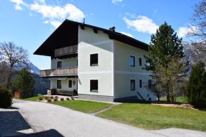 a large white house with a black roof at Ferienhof Hochbrandt in Spital am Pyhrn