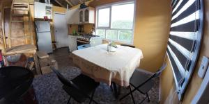 a kitchen with a table and chairs in a room at Cabañas Victoria Aucaco in Ancud