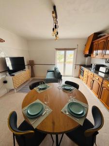 a dining room table and chairs in a living room at Apartamento - The Light House in Peniche