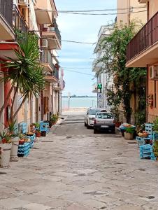 a street with buildings and a car parked on the street at B&B AeR in Lesina