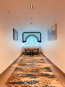 a living room with a couch and a rug at سديم الفخر 2 للشقق الفندقية in Taif