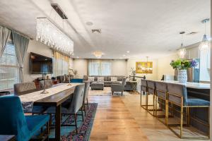 a living room with a long table and chairs at Charming Boston Retreat 3BR Parking Perfect for Families & Groups in Revere