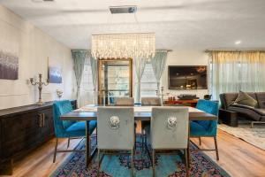 a dining room with a table and blue chairs at Charming Boston Retreat 3BR Parking Perfect for Families & Groups in Revere