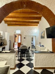 a living room with a table and a checkerboard floor at Il Cortiletto di Ortigia in Syracuse