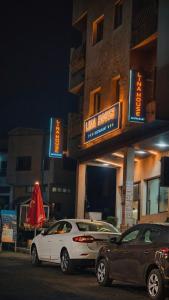two cars parked in front of a building at night at lina imsouane in Imsouane