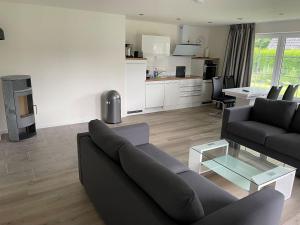 a living room with a couch and a table at Seaside-Amrum-5 in Norddorf