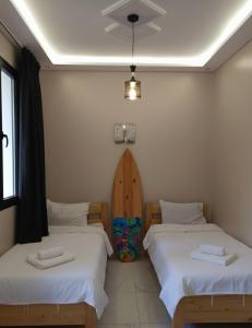 a room with two beds in a room at lina imsouane in Imsouane +8 photos