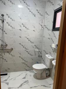 a bathroom with a toilet and a sink at lina imsouane in Imsouane